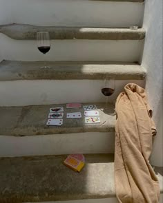 a towel is sitting on the steps next to some cards