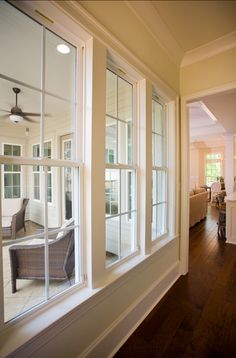 a living room filled with furniture and lots of windows