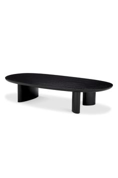 a black oval table sitting on top of a white floor