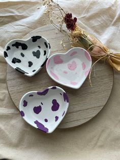 three heart shaped dishes sitting on top of a table