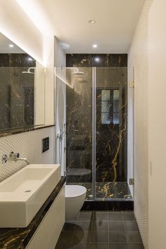 a bathroom with black and white marble walls