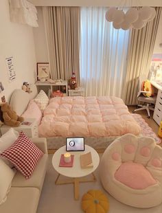 a room with a bed, couch and table in it