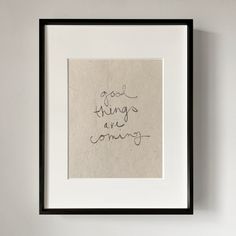 a handwritten message on a piece of paper in a black frame hanging on a wall