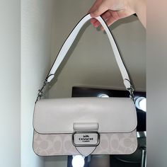 Brand New Beautiful White Coach Bag. Very Pretty Bag With A Lot Of Space And A Lot Of Pockets. It Has Never Been Used And It Still Has The Plastic Wrapping That It Originally Came With. White Rectangular Flap Bag With Branded Hardware, Everyday Tote Flap Bag With Branded Hardware, Everyday Flap Shoulder Bag With Branded Hardware, Beige Shoulder Flap Bag With Branded Hardware, Everyday Clutch Bag With Silver-tone Hardware, Coach Shoulder Bag With Silver-tone Hardware, White Clutch Bags With Silver-tone Hardware, Coach Beige Shoulder Bag With Silver-tone Hardware, Everyday Baguette Satchel Bag With Branded Hardware