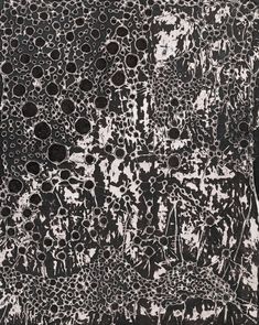 an abstract painting with black and white paint on the bottom, surrounded by smaller circles