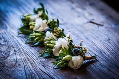 some flowers are laying on a wooden table