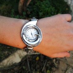 From Porans watches collection: Unique sterling silver watch bracelet for women Inspired by the depth of the sea. Dimensions: Max front Width: 3.5 cm. Min back width: 1 cm. Size: Can be any size you want. Our watch is top quality stainless still, analog, Japanese movement with water resistance (up to 3 atmospheres) and it is powered by a battery that lasts about 3 years. The battery can be exchanged. Please notice that because the watch is made to order the watch mechanism part may look differen Silver Watch With Rotating Bezel As Gift, Silver Watches With Rotating Bezel As Gift, Silver Watches With Rotating Bezel For Gift, Silver Round Analog Watch, Watch Mechanism, Watches Collection, Watch For Women, Watch Bracelet, Shell Earrings