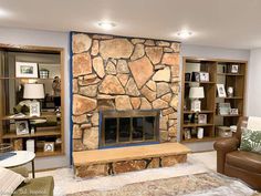 a living room filled with furniture and a stone fireplace