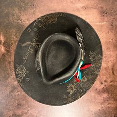 Rancher style cowboy hat for cowgirls custom burned by hand exclusively for Bourbon Cowgirl! We worked with this popular designer to create our very own look. 100% wool rancher hat in black which looks great with every outfit. One size fits all, as the interior band is adjustable to fit most. A beautiful rancher style with a pinch crease, this gorgeous black cowgirl hat is sanded and torched to a beautifully burnished and distressed finish. Firm shape (do not crush). Our artisan has hand burned