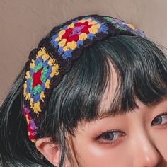 a close up of a person wearing a headband with flowers on it's side