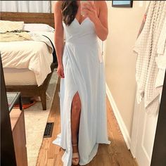 a woman in a white dress taking a selfie