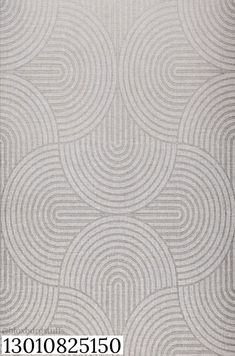 an area rug with circles on it in grey and white colors, as well as a pattern