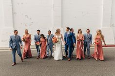 a group of people standing next to each other in front of a white brick wall