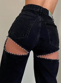 the back of a woman's jeans with holes in it