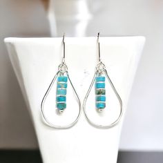 Get ready to turn heads with these Lane sterling silver hoop earrings! The teardrop design adds a unique touch, while the turquoise dangle provides a pop of color. Elevate any outfit with these playful and fun earrings. Approximately 1.75” long Made with .925 Sterling Silver Turquoise Jasper Gemstones Polished to a high shine Handmade in Montana Sent in a ribboned gift box with polishing cloth Turquoise Sterling Silver Nickel-free Hoop Earrings, Turquoise Sterling Silver Hoop Earrings, Nickel-free Turquoise Teardrop Earrings, Sterling Silver Turquoise Hoop Earrings, Modern Teardrop Turquoise Jewelry, Nickel-free Turquoise Teardrop Hoop Earrings, Nickel-free Teardrop Turquoise Hoop Earrings, Teardrop Turquoise Nickel-free Hoop Earrings, Turquoise Teardrop Nickel-free Hoop Earrings