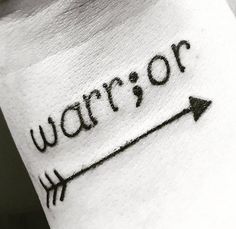 a wrist tattoo with the word warrior written in cursive writing on it and an arrow