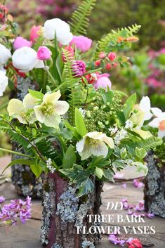 there are many different flowers in the vases on the wooden table with purple and white flowers