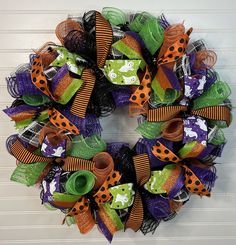 Halloween Wreath-Halloween door wreath-Halloween door decor-Halloween decor-Halloween wreath for front door-Halloween mesh wreath-Halloween Get ready to impress neighbors, friends and trick or treaters this Halloween. This wreath is guaranteed to make you the envy of the neighborhood. It is full of texture. This wreath is made on a work wreath base using premium deco mesh and premium wired ribbons in coordinating patterns and textures.  This wreath measures 24-25" in diameter and is 6-7" deep. T Halloween Door Wreaths, Halloween Mesh Wreaths, Trick Or Treaters, Work Wreath, Wreath Base, Halloween Wreaths, Wreath Halloween, Halloween Door Decorations, Coordinating Patterns