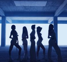 the silhouettes of four women are standing in an empty room