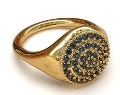 a gold ring with blue and white stones on the front, set in 18k yellow gold