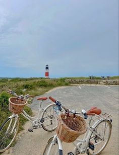 two bicycles parked next to each other in front of a light house