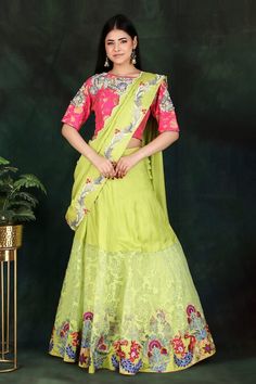 Parrot green lehenga saree with floral and thread hand embroidered pallu. Comes with a magenta padded blouse and a petticoat with an attached cancan. - Aza Fashions Green Lehenga With Dori Work For Navratri, Green Lehenga With Dori Work For Festive Occasions, Festive Green Lehenga With Dori Work, Semi-stitched Green Lehenga With Pallu, Green Lehenga With Dori Work, Green Art Silk Lehenga With Zari Work, Green Art Silk Lehenga With Dupatta, Traditional Green Pre-draped Saree With Sheer Dupatta, Bollywood Style Green Art Silk Lehenga