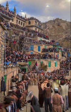 a crowd of people standing on the side of a road