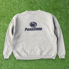 Show your school spirit with this Penn State Nittany Lions Gray Sweatshirt. Featuring a graphic of Pennsylvania State University, this crewneck sweatshirt is perfect for showing your support for the Nittany Lions. The gray color adds a versatile and classic touch to your outfit. Made with comfort in mind, this XL youth-sized pullover offers a cozy fit for young fans. Whether you're attending a game or simply want to represent your school, this Penn State Nittany Lions Gray Sweatshirt is a must-have addition to your collection. Embrace the pride of Pennsylvania State University and stay warm in style with this iconic crewneck pullover. 📏Measurement:📏 Size on Tag: XL Youth Width (Pit to Pit): 24" Length (Neck to end of garment): 24" Sleeve Length (Neck to end of cuff): 27.5" 👕Condition: G College Crew Sweater With Logo Print, University Logo Cotton Sweatshirt Fan Gear, University Logo Cotton Sweatshirt For Fans, University Logo Cotton Sweatshirt For Fan Gear, University Logo Long Sleeve Tops For Streetwear, Collegiate Crew Neck Sweatshirt Fan Gear, Collegiate Logo Print Sweatshirt For Fall, Collegiate Crew Neck Sweatshirt For Fan Gear, College Logo Print Crew Neck Sweatshirt