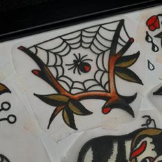 some stickers are sitting on top of each other in the shape of animals and spider webs