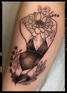 a woman's leg with tattoos on it