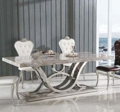 a marble dining table and chairs in a room