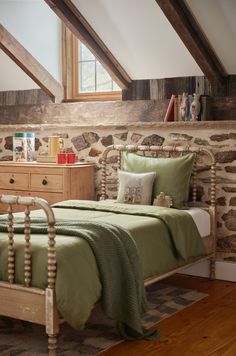 a bed with green sheets and pillows in a room