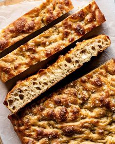 slices of bread sitting on top of a piece of parchment paper next to each other