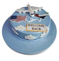 a welcome back cake with an airplane on top