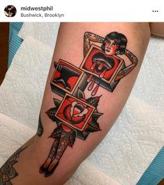 a woman's leg with tattoos on it and an image of a man holding a heart