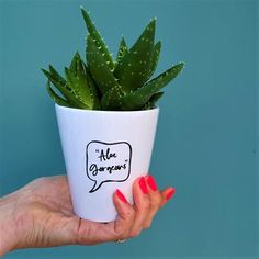 a woman holding a potted plant with an ad on it's side and the words, aloe gonzon written in a speech bubble