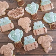 decorated cookies are arranged on a wooden table with the words adventure written in frosting