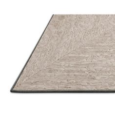 a white and black rug on top of a wooden floor with an area for text