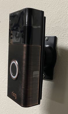 a ring video camera mounted to the side of a wall