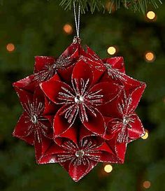 a red ornament hanging from a christmas tree