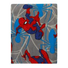 a spiderman blanket with blue and red webs on it