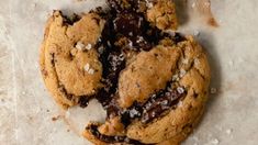 a chocolate chip cookie with coconut flakes on the top and one half broken in half