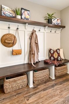 a bench with baskets and coat hooks on it