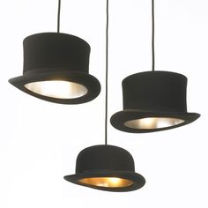 three hats are hanging from the ceiling with lights on them and one is wearing a top hat