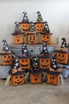 a bunch of pumpkins that are sitting on top of some buckets in the shape of jack - o'- lanterns