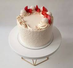 a cake with white frosting and strawberries on top