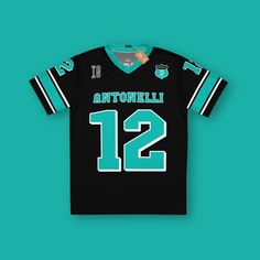 a jersey with the number 12 on it is hanging up against a turquoise background,