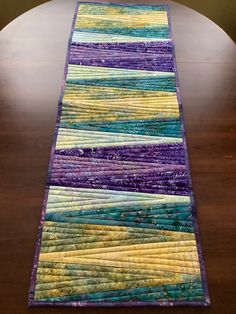 a table runner made out of strips of fabric