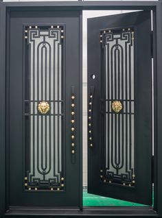 two black double doors with gold handles and glass inserts on each door, one has a lion's head at the top