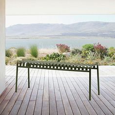 a bench sitting on top of a wooden deck